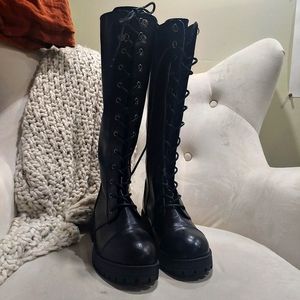 Knee high corset lace up boots.